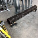 Large-diameter pipe section staged on-site for a commercial water line installation