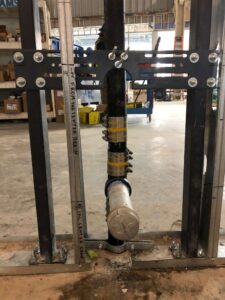 Copper riser piping installed between floors in a commercial building under construction
